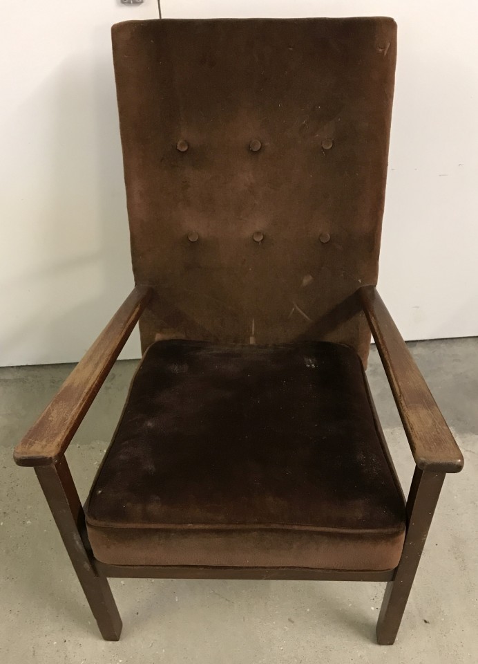 A vintage wooden framed easy chair with brown velvet upholstery.