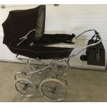 A 1970's coach built brown Marmet pram.