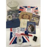 A collection of royal memorabilia to include glass bowl, plastic flags, books and ceramics.