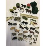 A box of vintage lead farm animals and accessories.