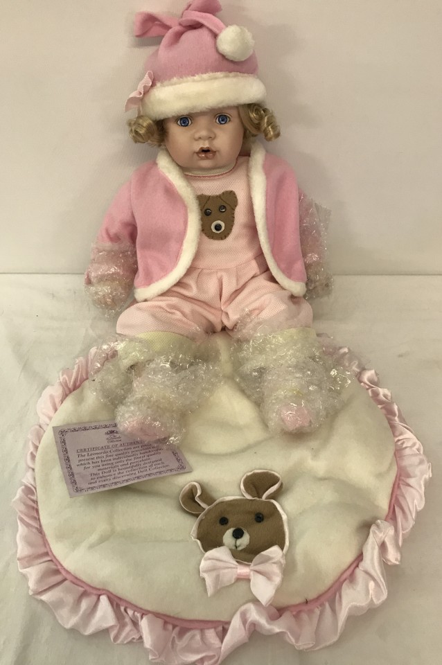 A boxed Leonardo collection collectors baby doll with teddy bear blanket.