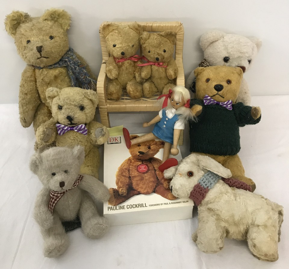 A collection of vintage teddies and other items.