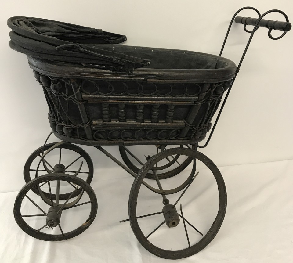 A vintage wooden framed dolls pram.