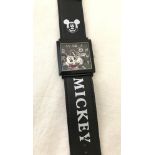 A large square face Disney Mickey Mouse wristwatch.