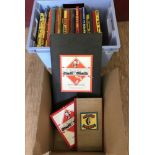 A collection of assorted vintage board games and annuals.