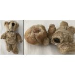 A vintage blonde haired teddy bear perfume bottle with padded hands and feet.
