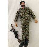 A vintage action man with beard in camouflage outfit with beret and gun