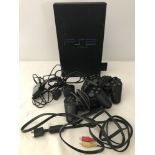 A Sony Playstation 2 console together with 2 wired controls and leads.