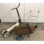 A vintage 3 wheeled Play-Way Scooter together with a toy sack barrow & a tin Wheel barrow.