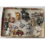 A tray of miniature teddy bear figures and charms.