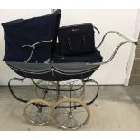 A c1970's Silver Cross dolls pram with accessories bag.