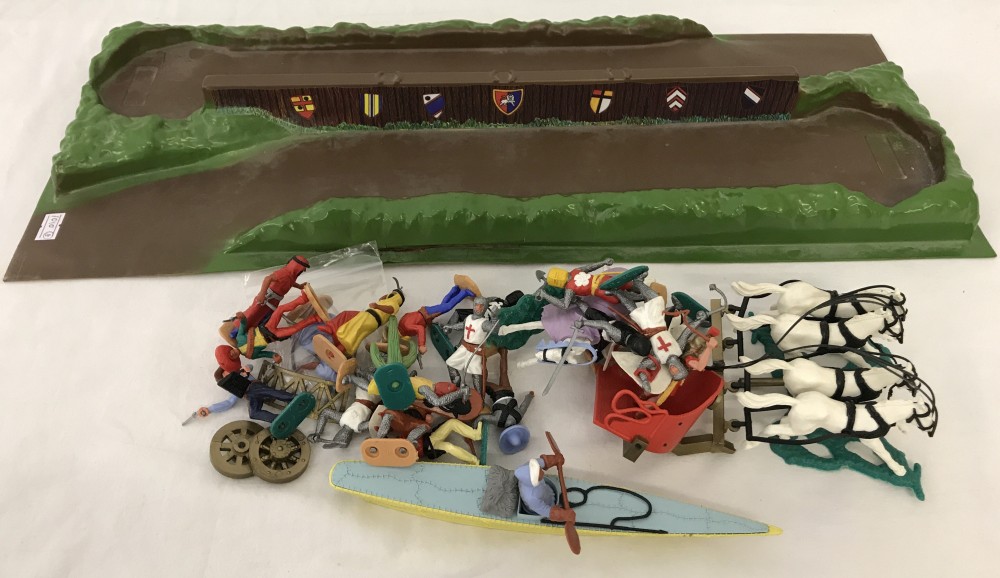 A collection of Timpo plastic soldiers with Knight's jousting play base.
