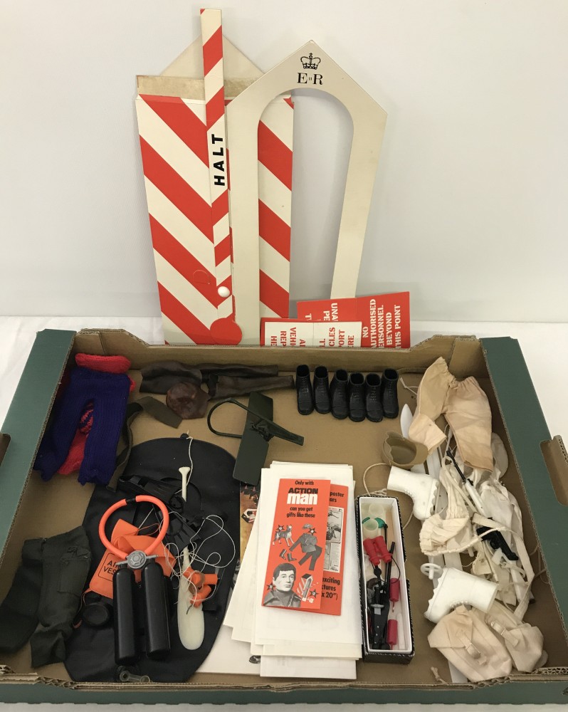 A box of vintage Action man outfits and accessories.