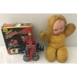A boxed vintage Robot Fighter together with a furry body Kewpie style doll.