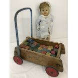 A vintage Tri-ang Baby walker with coloured wooden bricks, & a vintage 'walker' doll.
