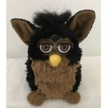 A 1998 Tiger Electronics black and brown interactive toy "Furby".