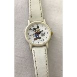 A white leather strap Mickey Mouse watch by Apollo.