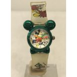 A Mickey Mouse wristwatch with Mickey head shaped case in metallic green.