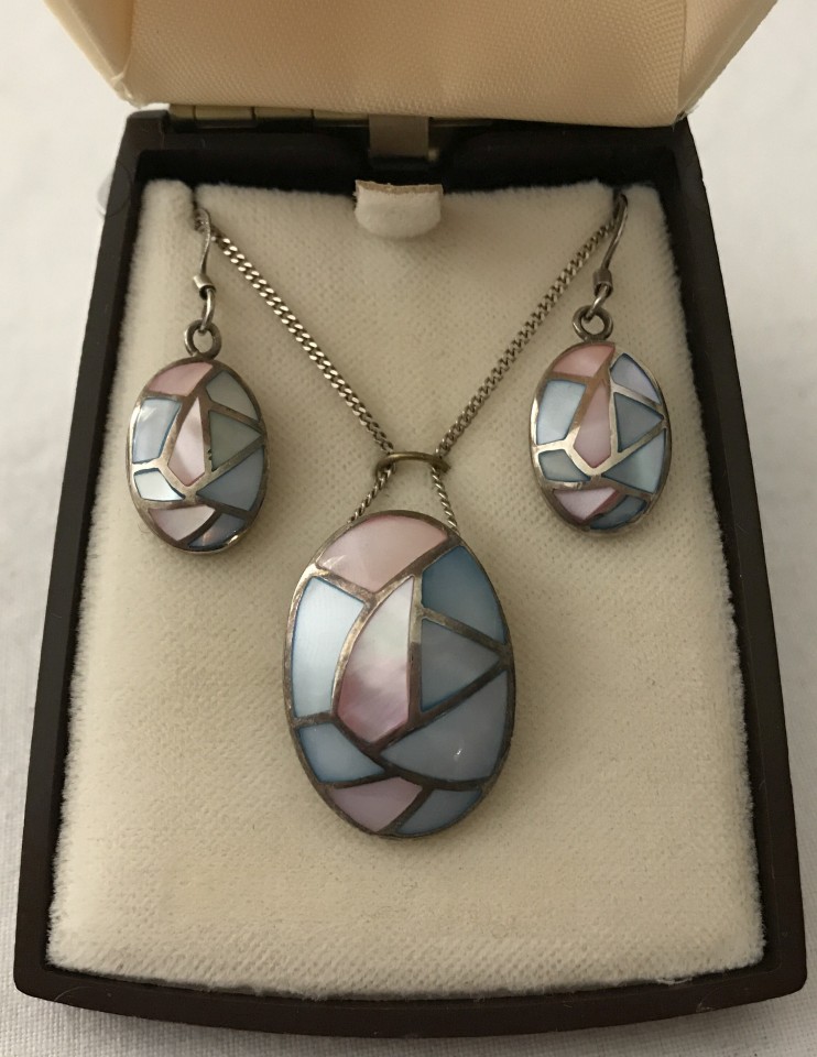 A 925 silver pendant and matching earrings set with mosaic style pink and blue mother of pearl.