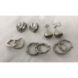 5 pairs of large silver earrings.