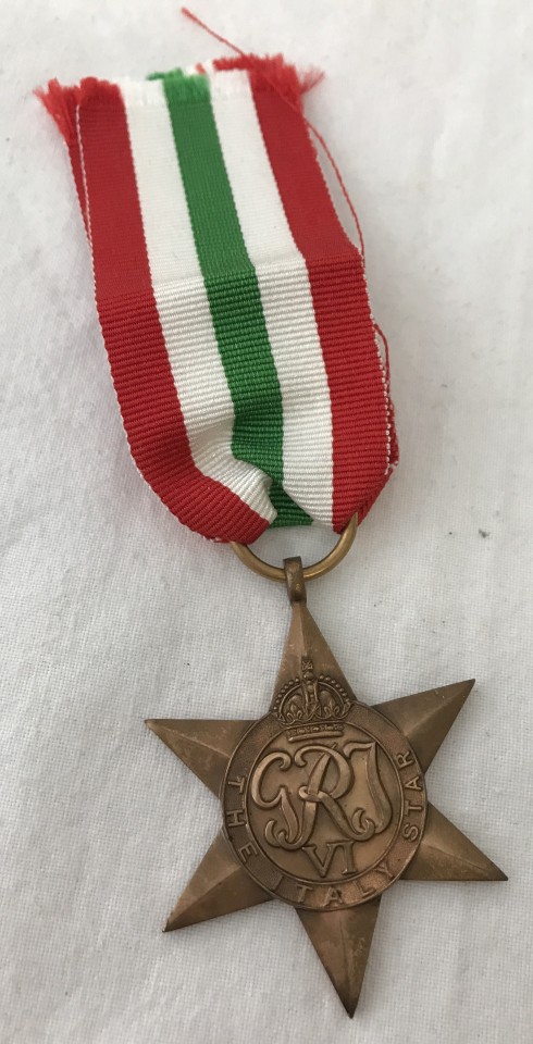 A WWII pattern The Italy Star medal on red, white and green ribbon.