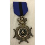 A Belgium order of Leopold II medal on blue/black ribbon.