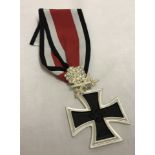 A reproduction WWII Knights cross with oak leaves and crystal "diamonds".
