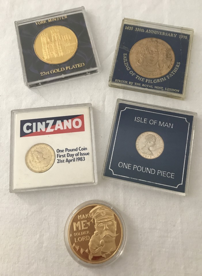 A collection of cased coins and commemorative medallions.