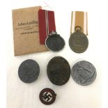 4 assorted WWII pattern German badges together with 2 WWII German medals.