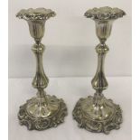 A decorative pair of silver plated candlesticks with removable sconces.