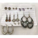 9 pairs of silver earrings.