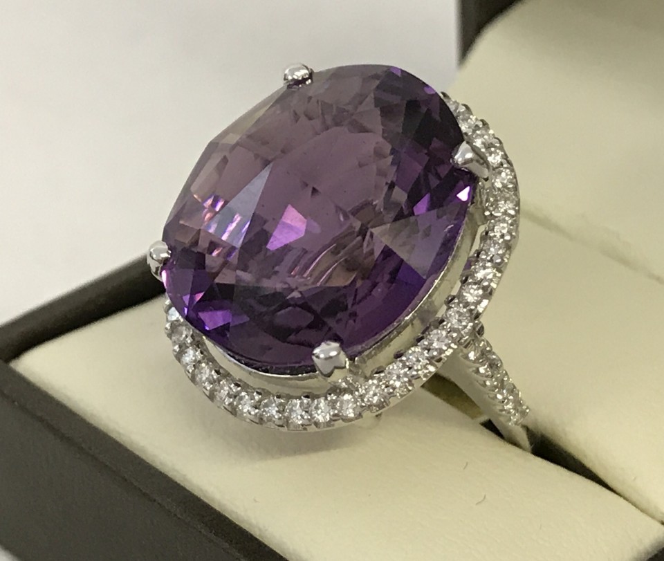 An 18ct white gold, very large Siberian (colour) Amethyst and diamond halo set cocktail ring.