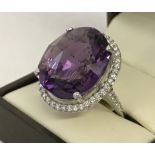 An 18ct white gold, very large Siberian (colour) Amethyst and diamond halo set cocktail ring.