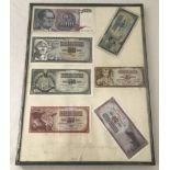 A framed collection of 7 Yugoslavian bank notes.