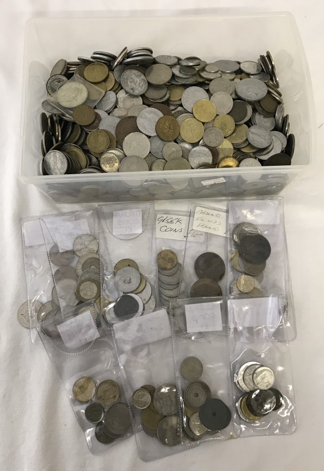 A tub of assorted foreign coins.