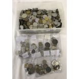 A tub of assorted foreign coins.