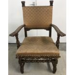 A large vintage wooden chair with upholstery to seat & back