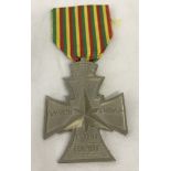 A WWII Ethiopian Victory Cross medal on yellow, green and red ribbon.