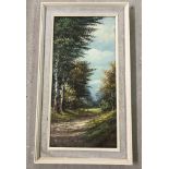 A framed oil on canvas of a woodland scene.