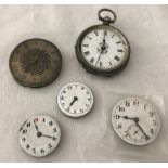 A antique ladies silver pocket watch without glass in need of repair.