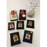 A collection of 7 assorted boxed East German medals together with a piece of the Berlin wall.