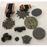 9 assorted German WWI and WWII pattern medals, badges and bits.