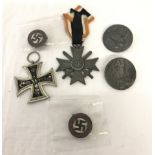 4 assorted WWII pattern German badges together with 2 German medals.