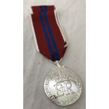 A 1953 Coronation medal on red, white and blue ribbon.