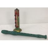 A vintage Heiwa Gakki tin whistle together with a green plastic recorder.