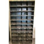 A large vintage metal industrial pigeon hole shelving unit.