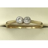 An 18ct yellow gold diamond ring. Elegant setting of two round cut diamonds 0.10 carat each.