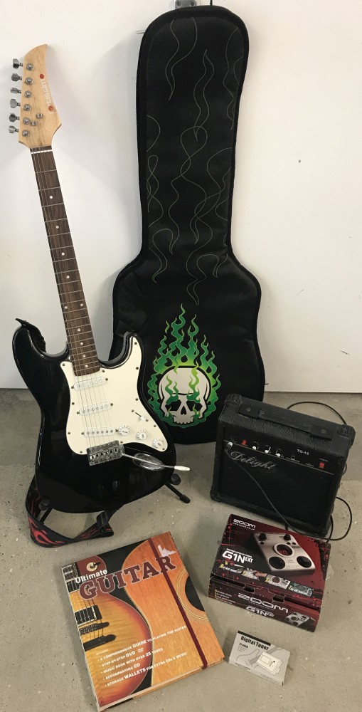 A Fortissimo black and white 6 string electric guitar together with a quantity of accessories.