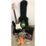 A Fortissimo black and white 6 string electric guitar together with a quantity of accessories.