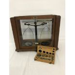 A vintage scientific scales with a box set of weights by Gallenkamp.